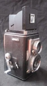 A second model Automatic Reflex. The flash sync post is at the bottom side of the lens board.