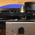 Left side of lens panel showing the aperture tape. The spring is used to maintain tension. The Rolleiflex T used a similar tape to show EV values.