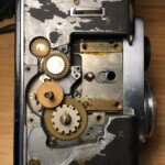 Right side with focus wheel and counter gears/wheel removed. The gear with the large, squared gaps is coupled to the counter wheel.
