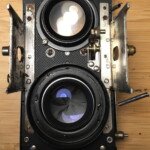 Back of the lens panel. On the lower left, you can see the original rivet for the aperture tape guide. On the right, you can see the replacement rivet (the original was drilled out) for the new flash sync post.